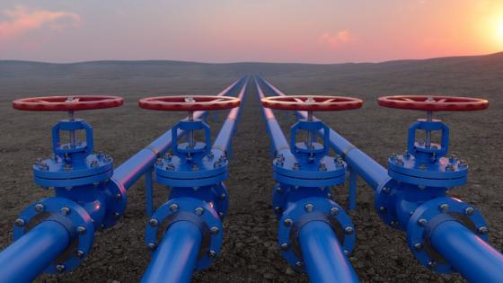 Oil Or Gas Transportation With Blue Gas Or Pipe Line Valves On Soil And Sunrise Background